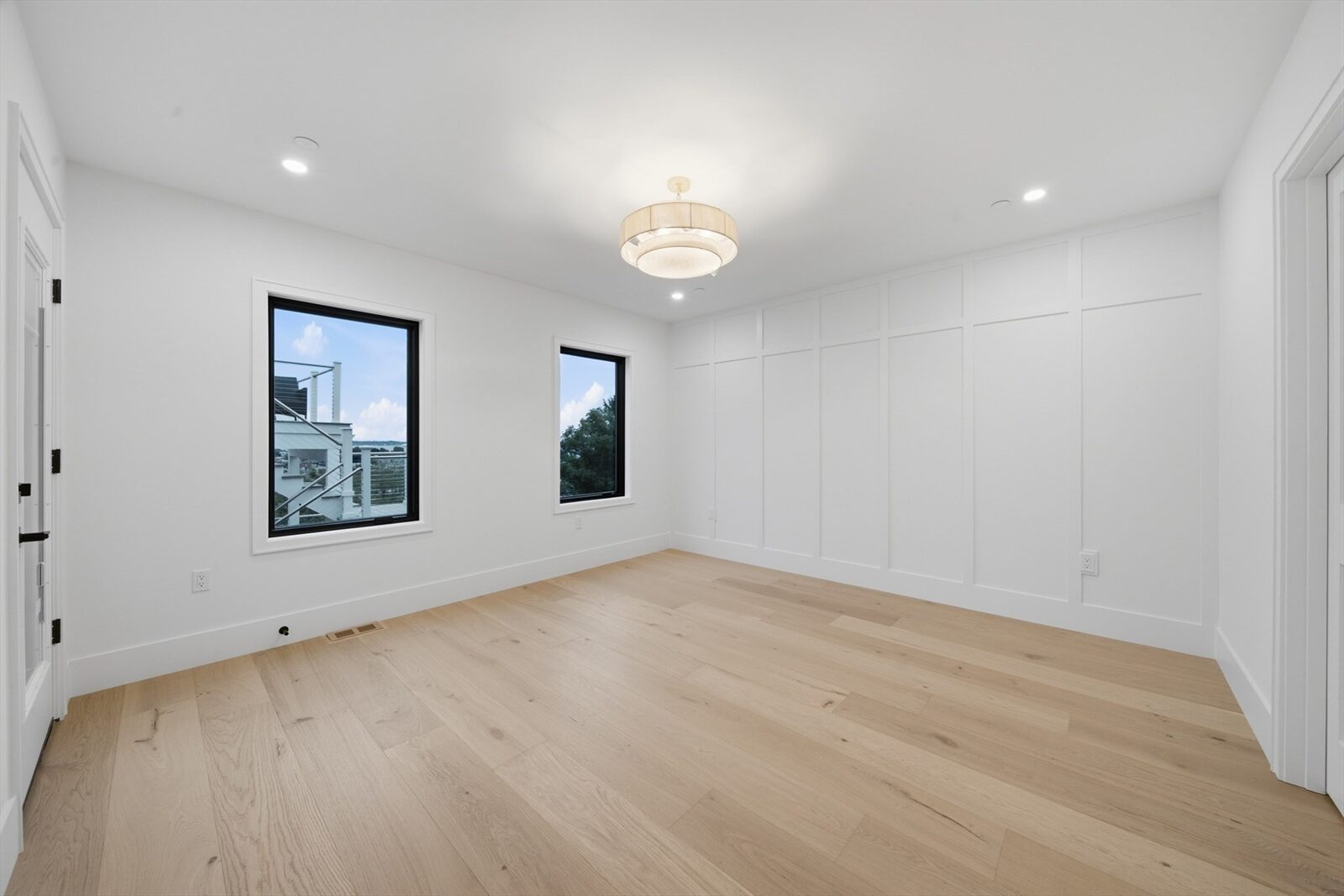 Upper-level room with windows at 421 East Sixth Street, Residence 3