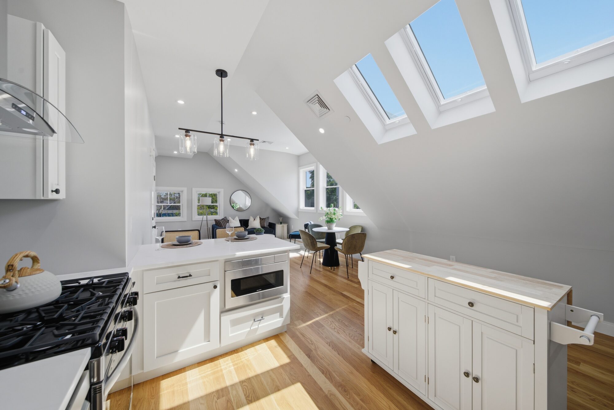 Kitchen looking toward the living area under triple skylights at 174 Walnut Street, Unit 3