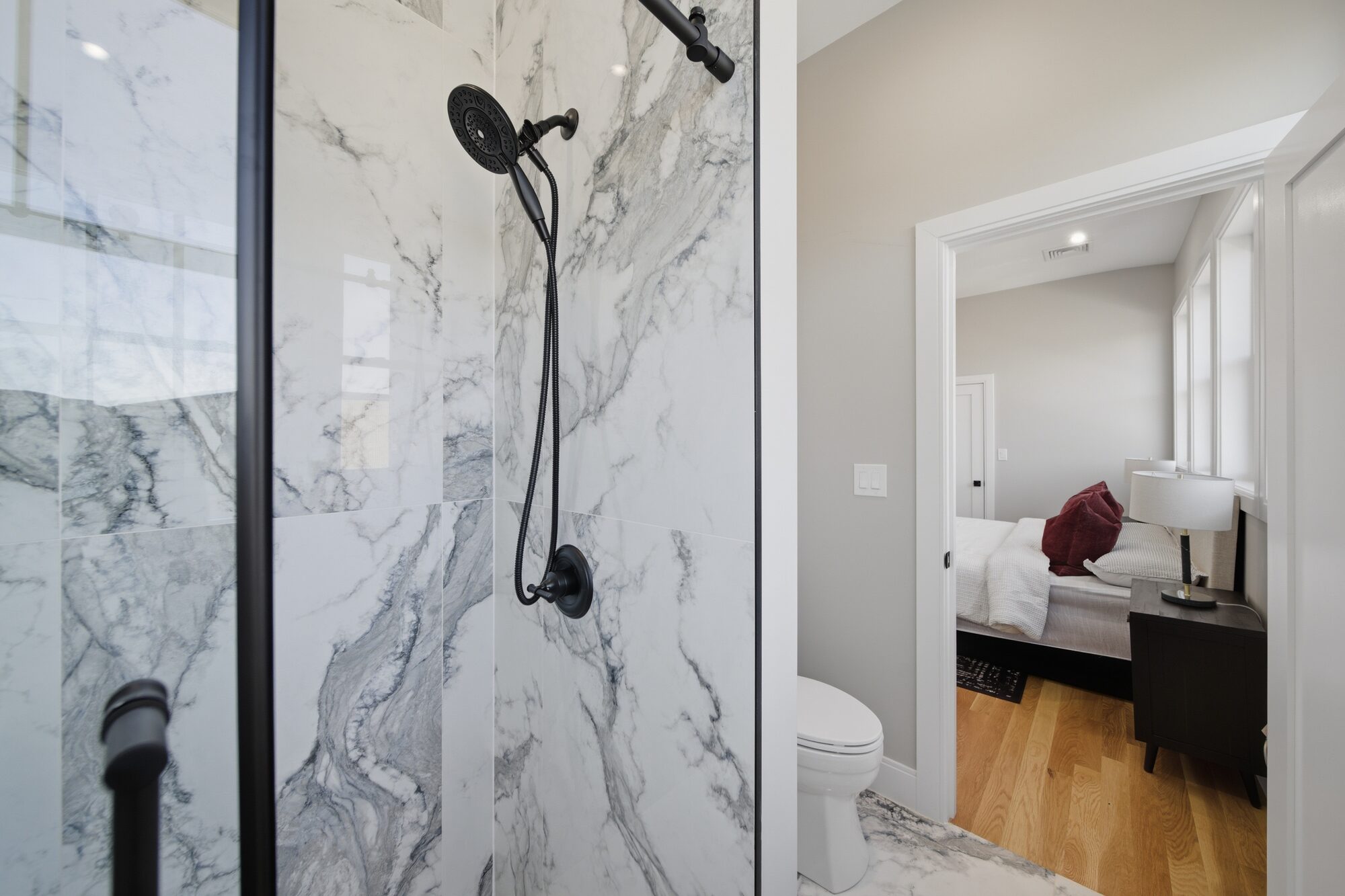Ensuite marble-tile shower looking into the bedroom at 174 Walnut Street, Unit 3