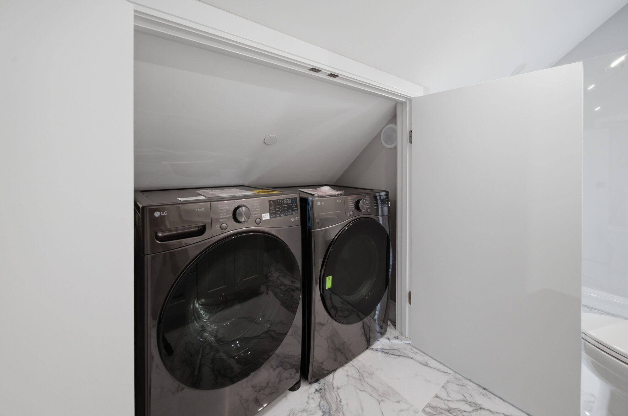 In-unit laundry with stacked LG washer and dryer alcove at 174 Walnut Street, Unit 3